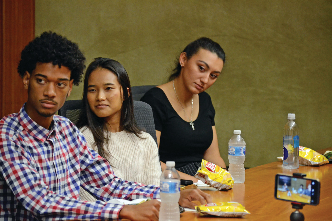 PROMISE IN PROGRESS: (l-r) David Mota of Pawtucket, Chantrea Heang of Warwick and Marissa Stevenson of Tiverton listen to CCRI President Meghan Hughes during the roundtable.